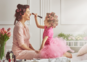 Mom and daughter putting on make up